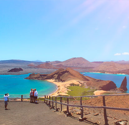 People taking a picture with the landscape of Bartolomé Island.